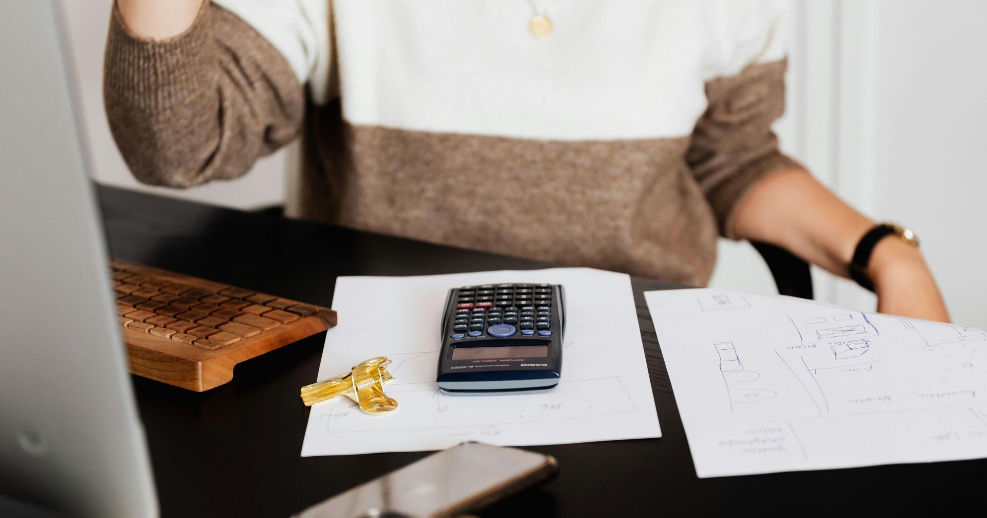 Black Calculator on top of Paper